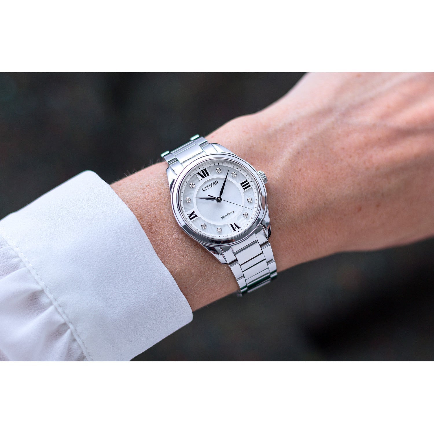 Model wearing the Citizen EM0870-58A, demonstrating its elegant and sophisticated wrist presence.