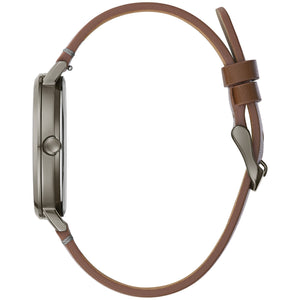 Side profile of the Caravelle by Bulova 44A120, showcasing the sleek grey steel case and the brown leather strap with a tang-type steel buckle.​