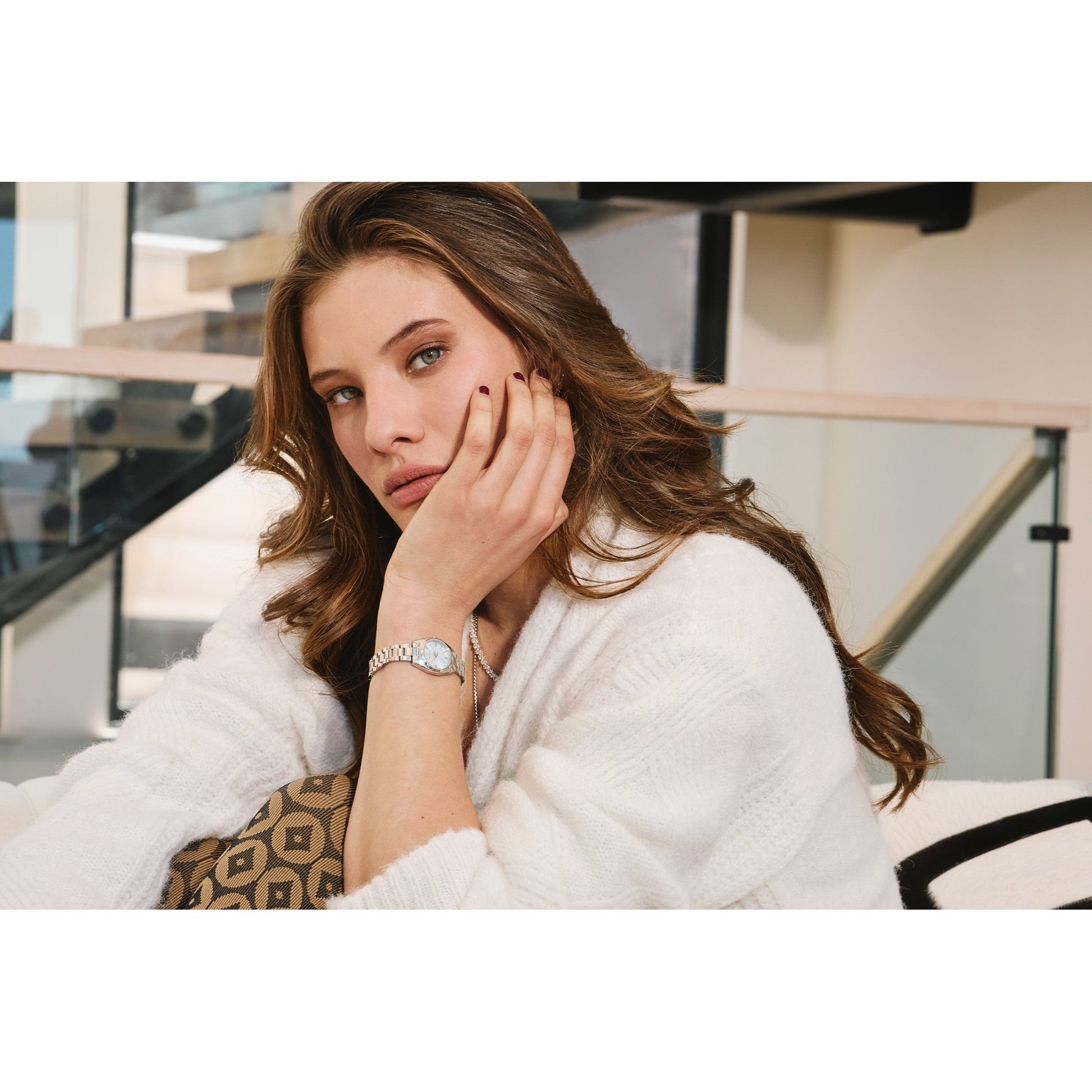 Model wearing Bulova 96L345 watch on wrist, showcasing the light blue dial and refined stainless steel bracelet in lifestyle setting.