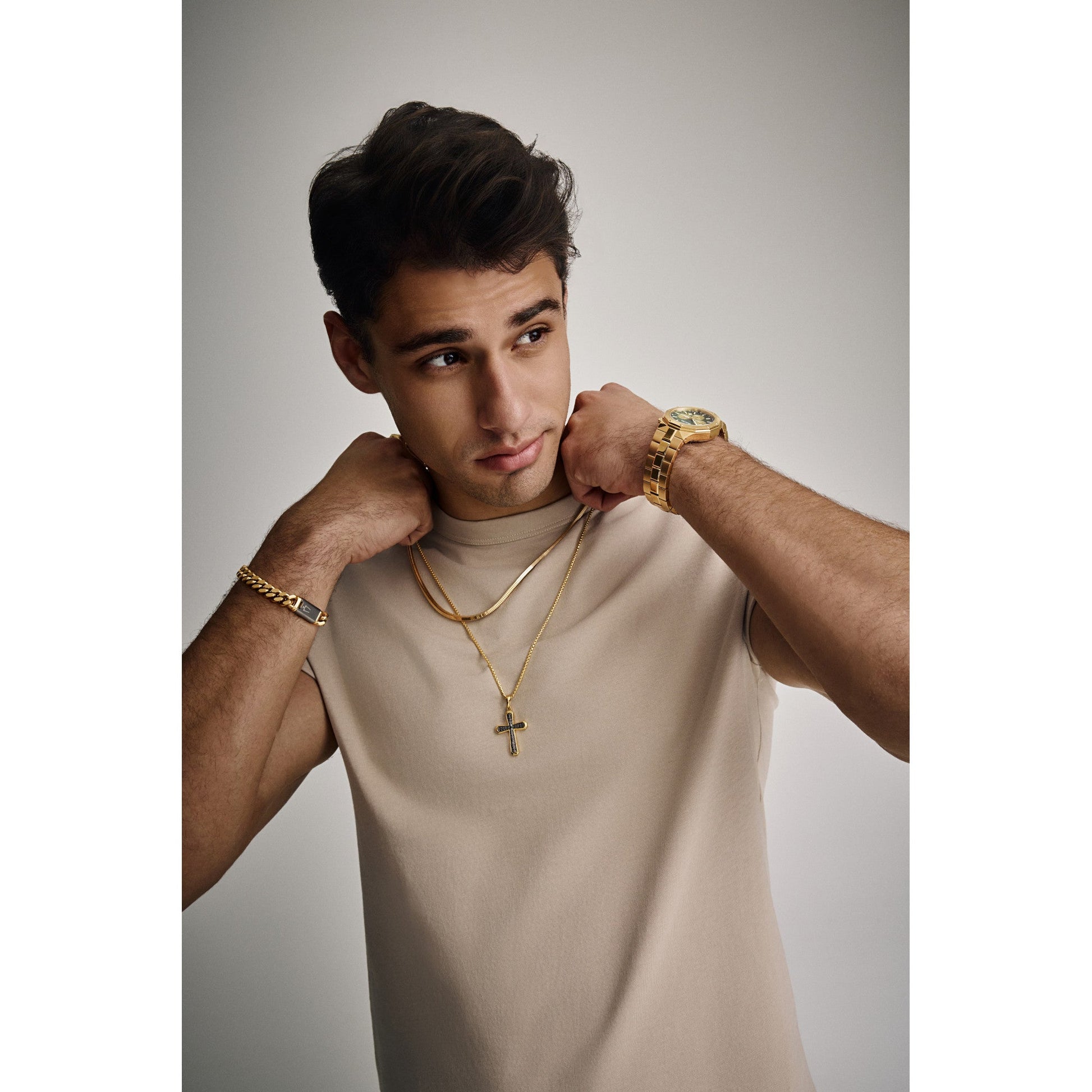 Model wearing the Bulova BVC1101-YSNA necklace, showing its 22” length and radiant gold finish styled over a shirt collar.
