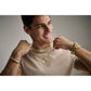 Model wearing Bulova BVP1141-YSWTO pendant — shield pendant resting at mid-chest over shirt, showing size and gold finish under ambient light.