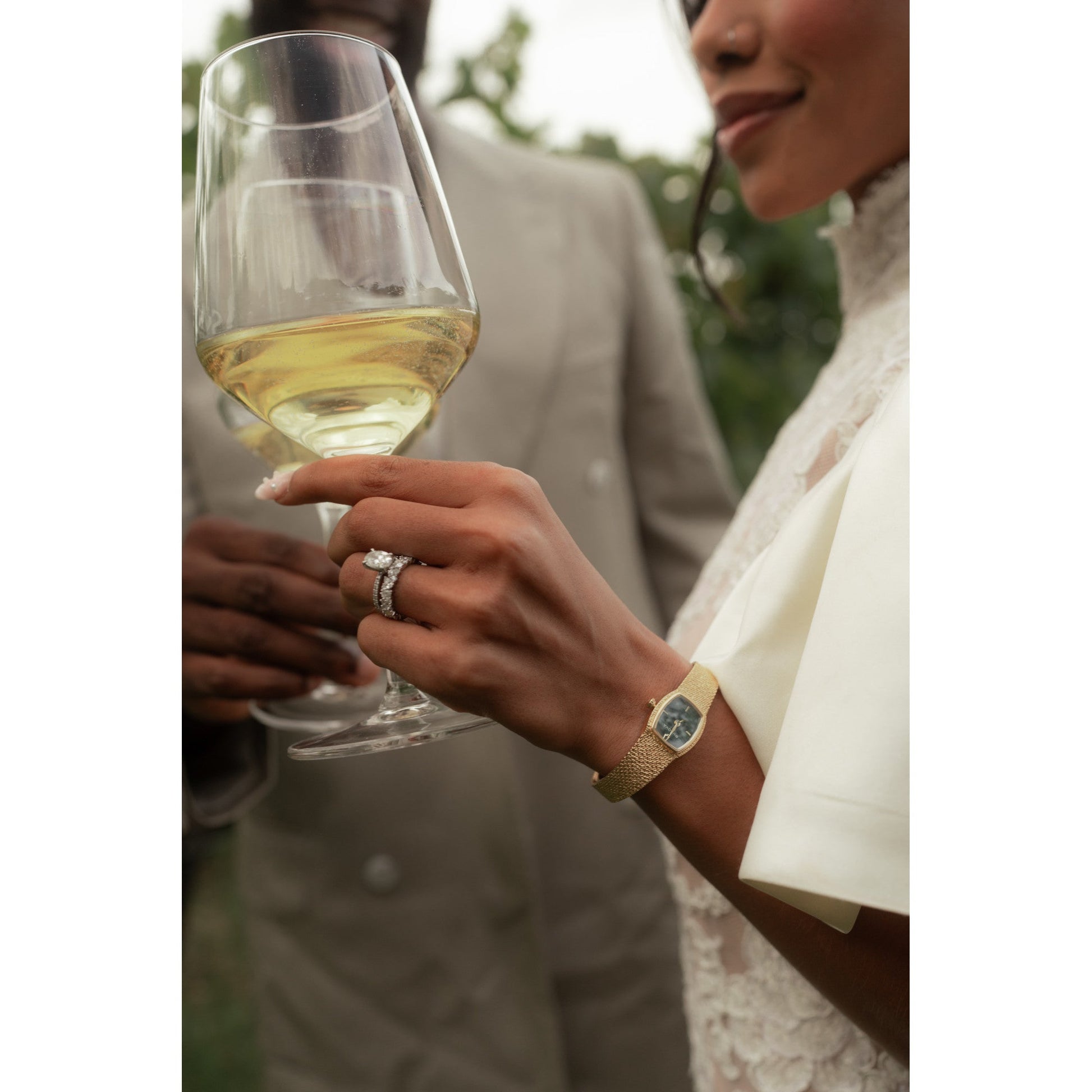 Model wearing the Bulova 97L184 on wrist, showcasing the green malachite dial and mesh bracelet in a refined lifestyle setting.