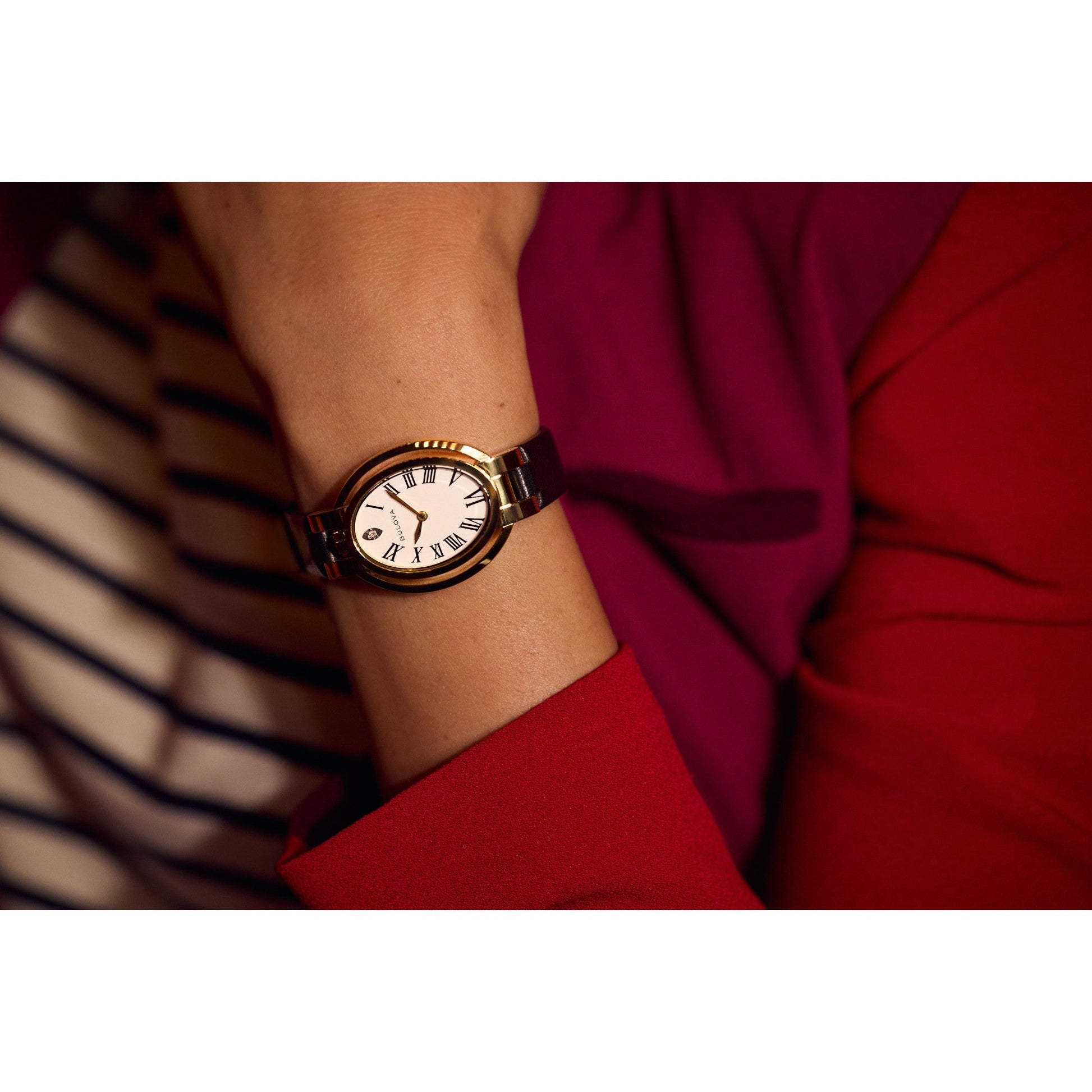 Model wearing Bulova 97P180 Rubaiyat “Ella” ladies’ watch — elegant and refined with white enamel dial contrasted against a black leather strap.