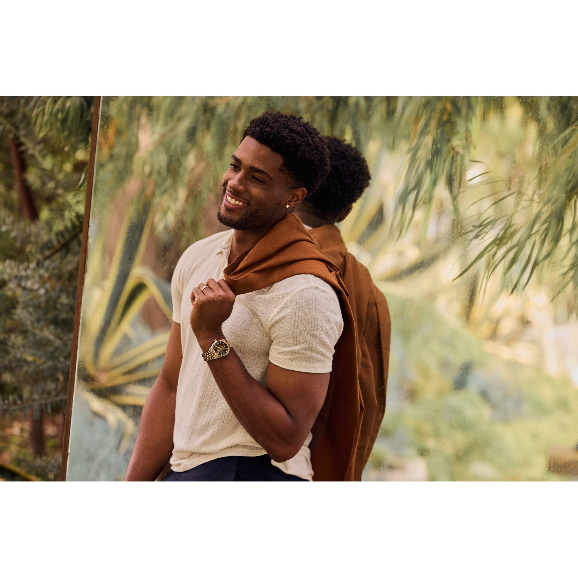 Model wearing the Citizen AW0156-57X, displaying its elegant two-tone finish and rich brown dial on the wrist.