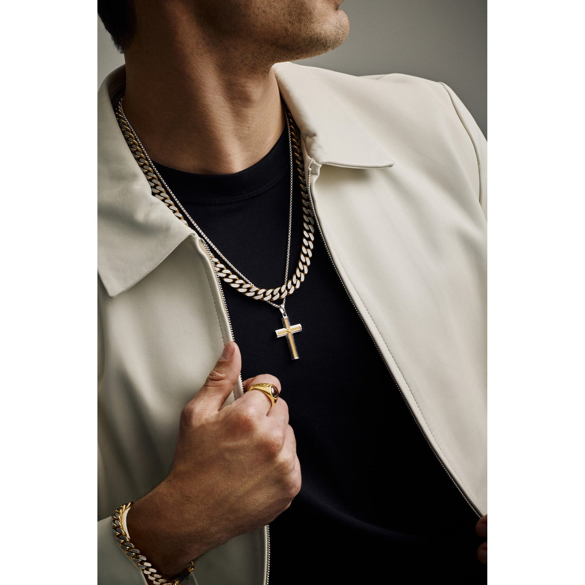 Model wearing Bulova BVP1156-WYSNA around the neck — cross pendant resting at mid-chest over a shirt, showing scale and two-tone finish.