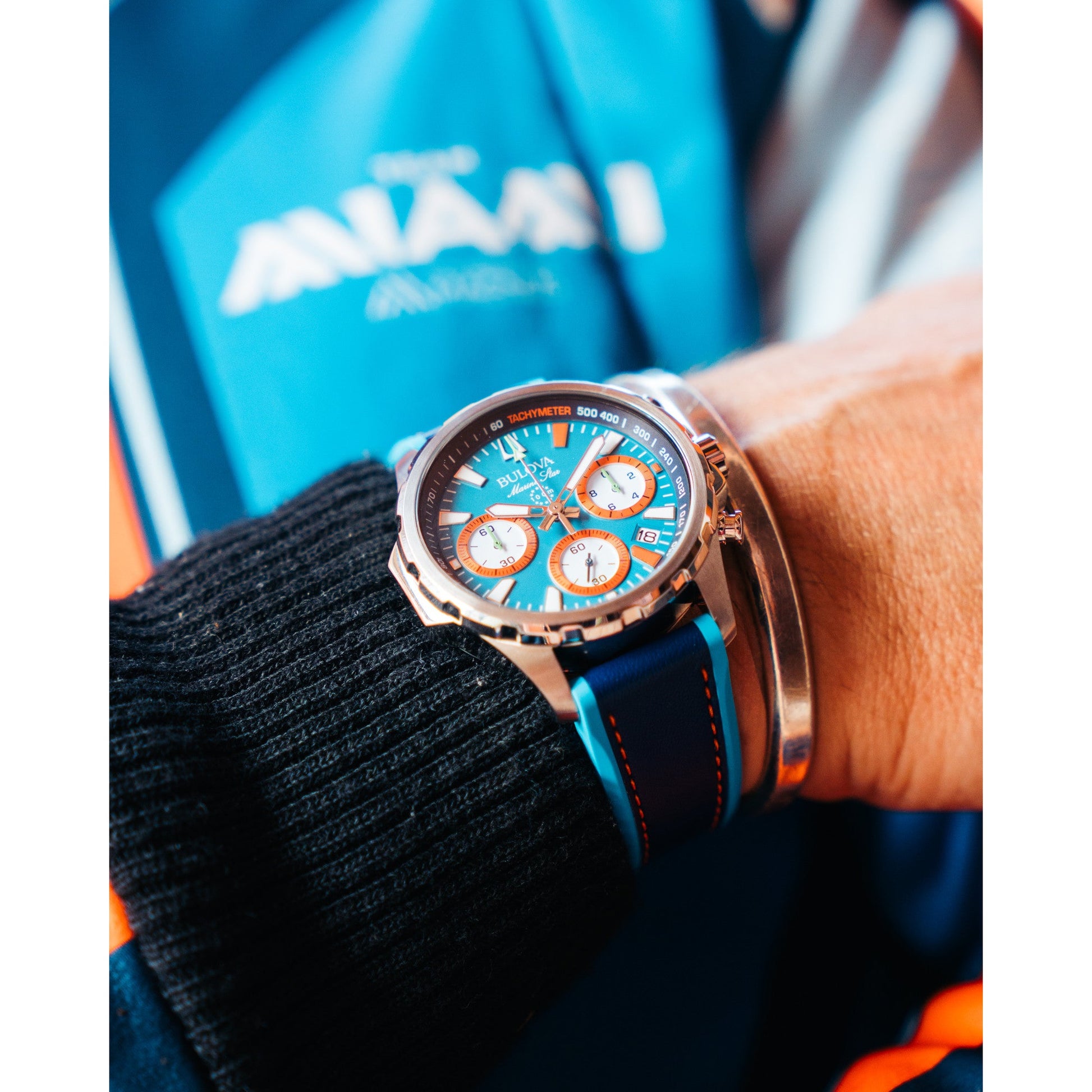 Model wearing the Bulova Marine Star E1 Team Miami Chronograph, highlighting its sporty design and vibrant color accents.