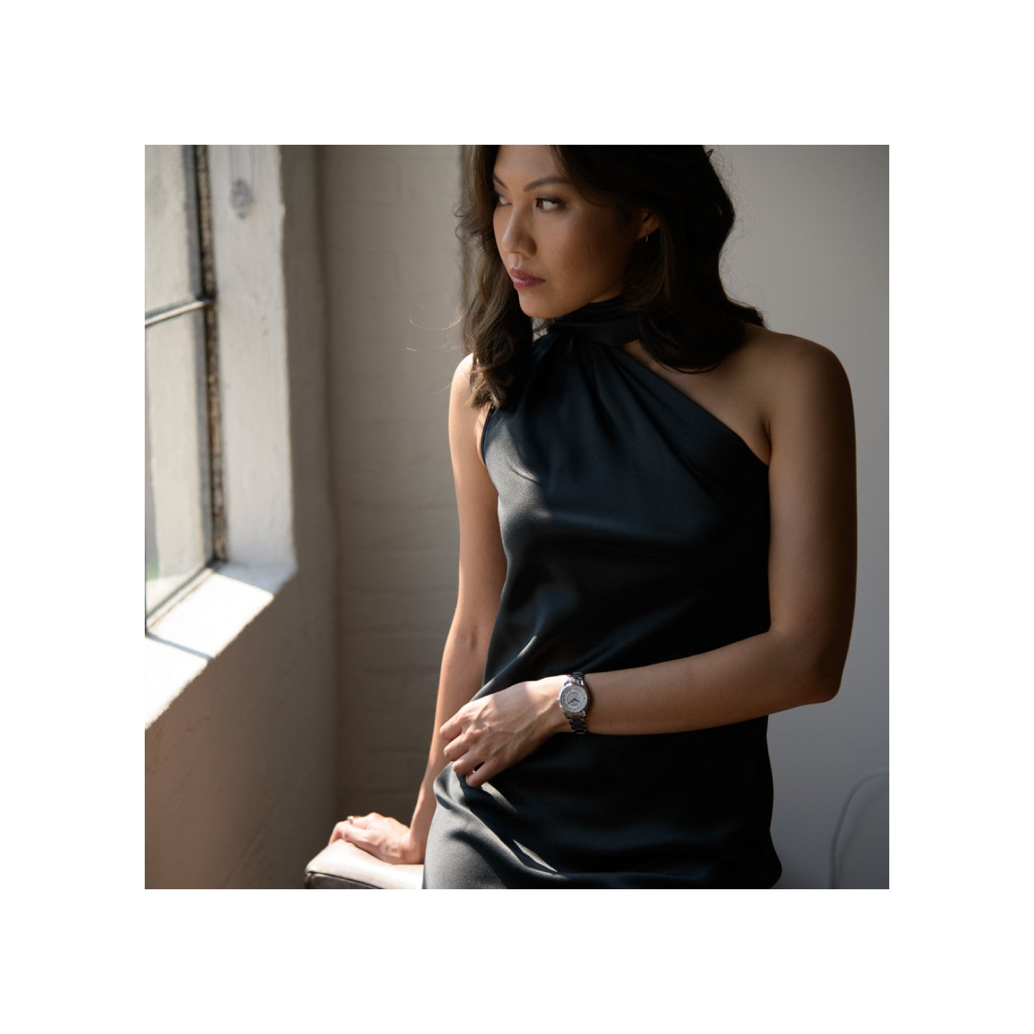 Model wearing the Citizen EM0870-58A, demonstrating its elegant and sophisticated wrist presence.