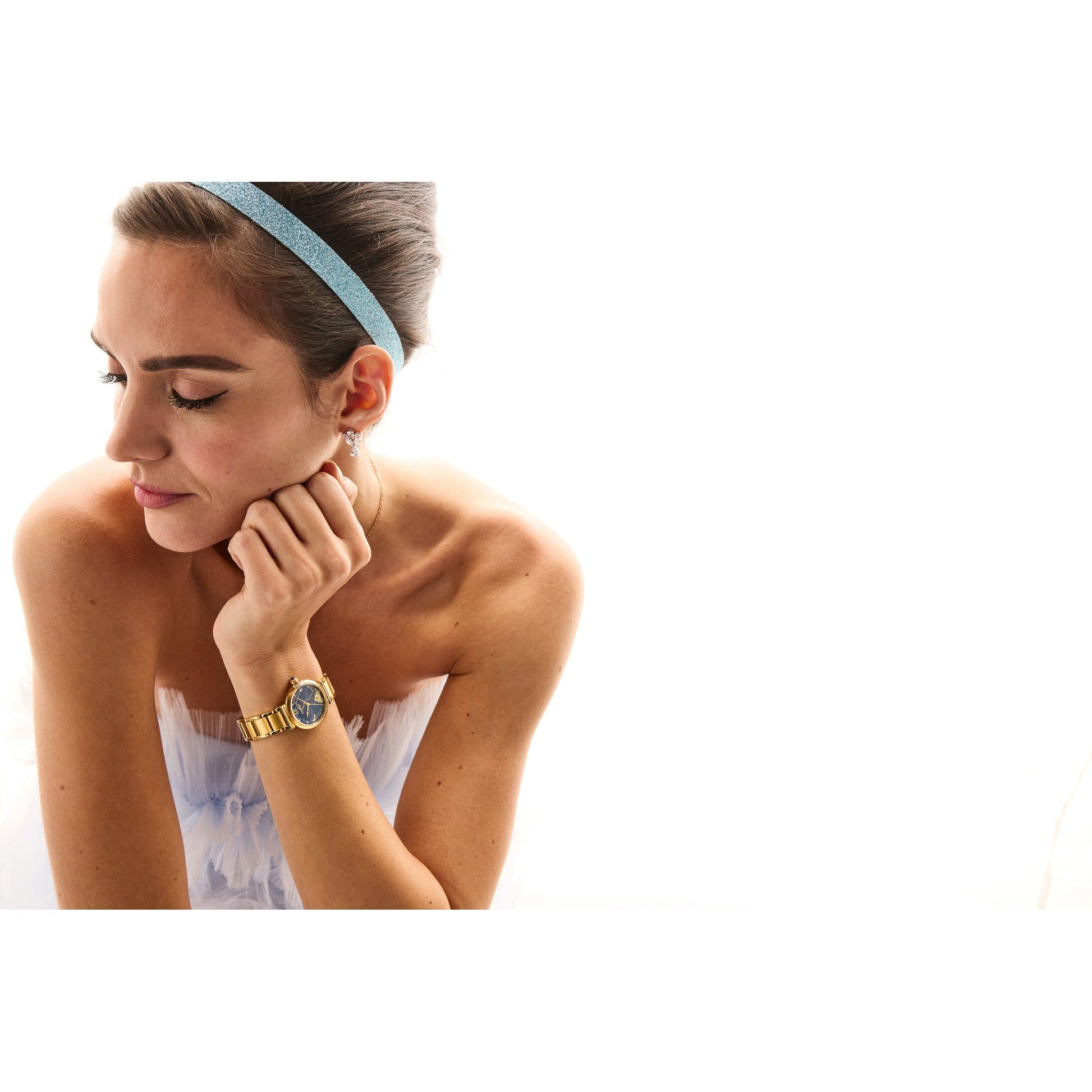 Model wearing Citizen EM1068-69W on the wrist, showcasing its elegant gold finish, blue dial, and fine bracelet in a premium setting.