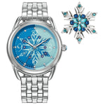 Front view of Citizen Disney Frozen Women's Watch Set FE7091-61W, showcasing the blue dial with snowflake pattern on the watch and the matching snowflake pin.