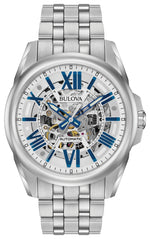 Bulova Sutton Automatic 96A187 men's watch featuring a skeleton dial with blue accents, luminous hands, and a stainless steel bracelet—front view.