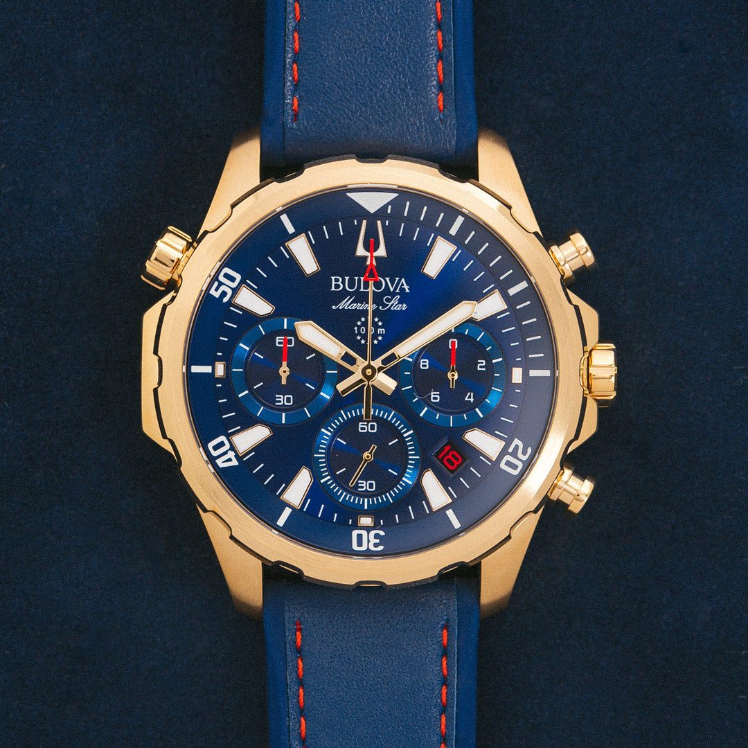 Bulova 97B168 Marine Star Chronograph featuring a blue dial with gold-tone accents and luminous hands—front view.