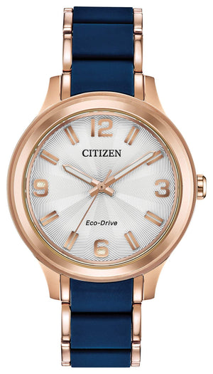 Citizen Drive Eco-Drive Ladies Watch FE7073-71A featuring a 36mm rose gold-tone stainless steel case with blue silicone center links and a silver-tone dial—front view