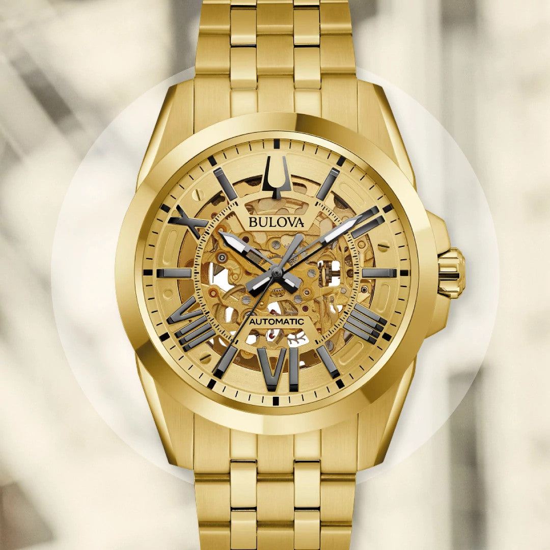 Bulova Sutton Automatic 97A162 men's watch featuring a gold-tone dial with open aperture, luminous hands, and a gold-tone stainless steel bracelet—front view.